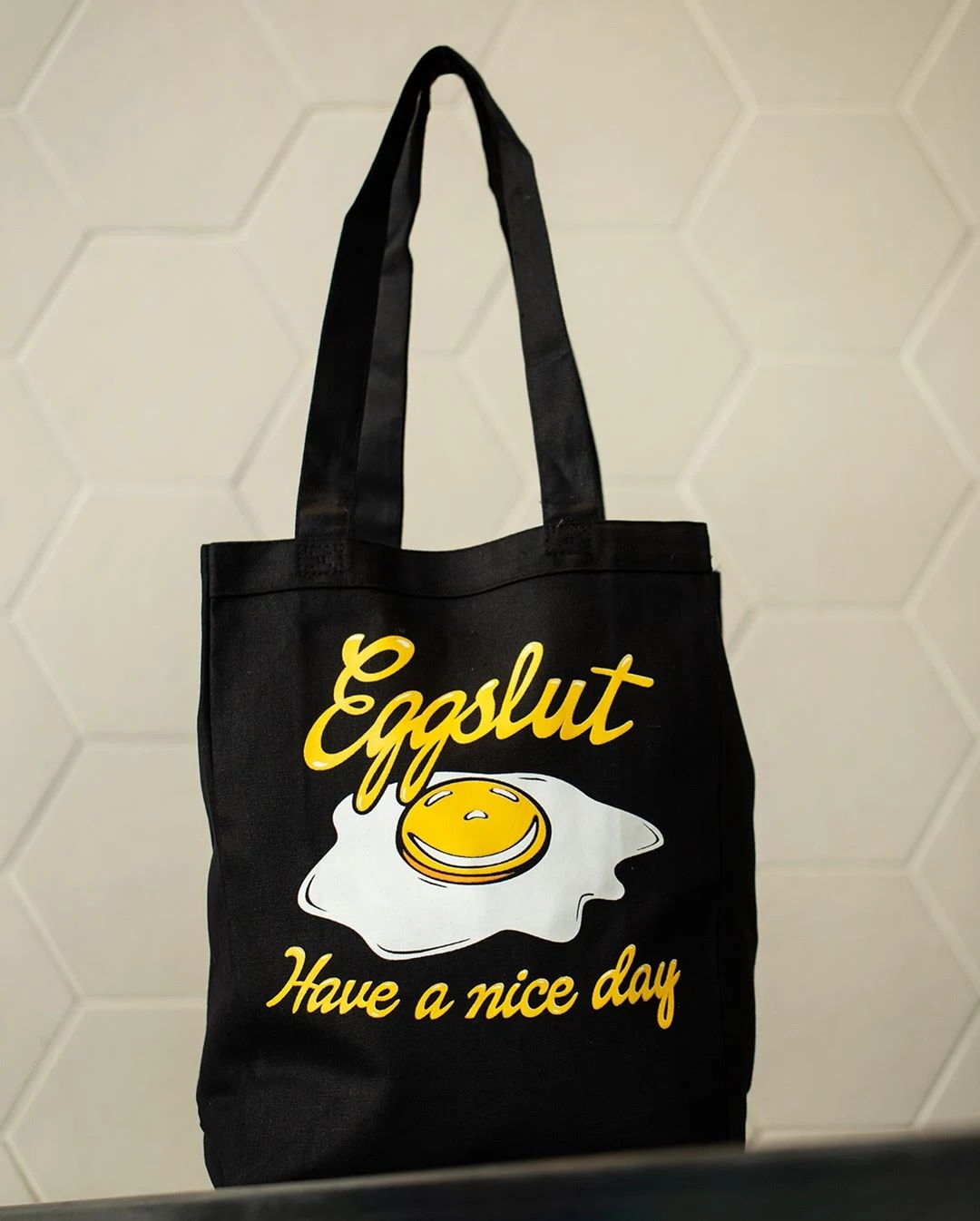 Eggslut x HBO: black tote bag printed with the Eggslut egg and "Have a nice day"